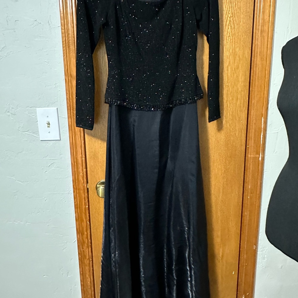 Full length, black dress with 3/4 sleeve.